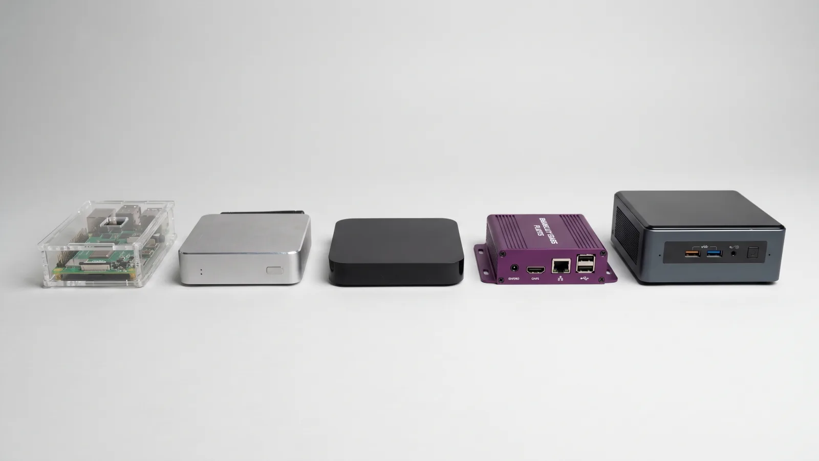 Side-by-side lineup of digital signage player hardware: commercial media player, BrightSign-style unit, Windows mini-PC, Android box, and Raspberry Pi
