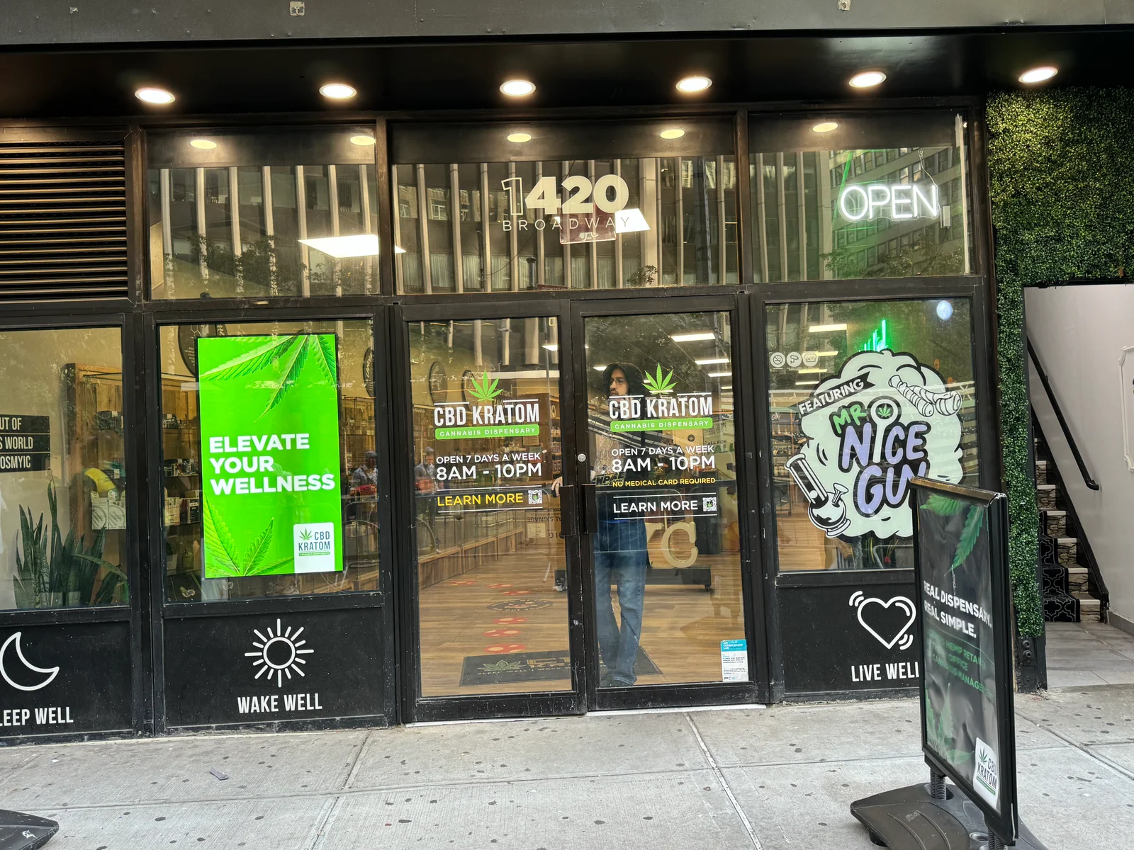 High-brightness window display in a CBD Kratom storefront behind glass.