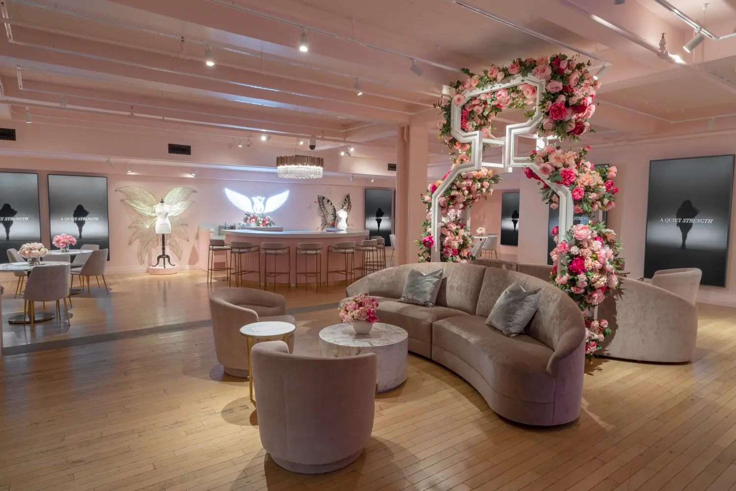 Victoria's Secret Fifth Avenue flagship upper-floor VIP lounge with seasonal floral installation