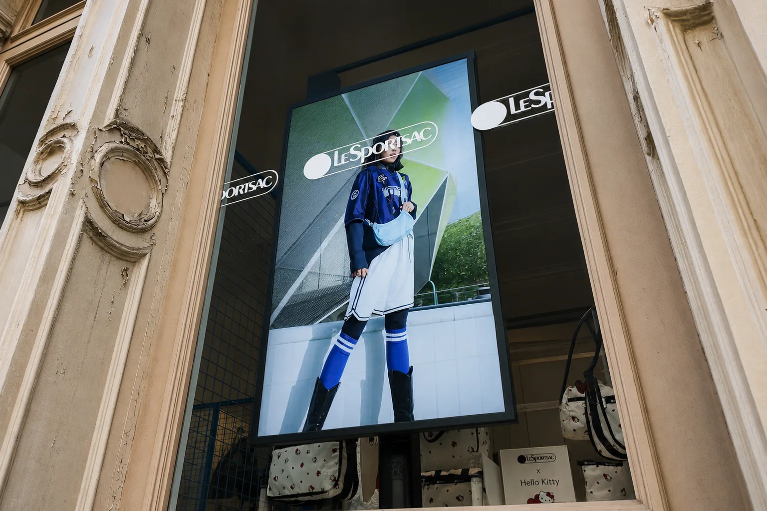 LeSportsac storefront high-brightness window display installed behind glass