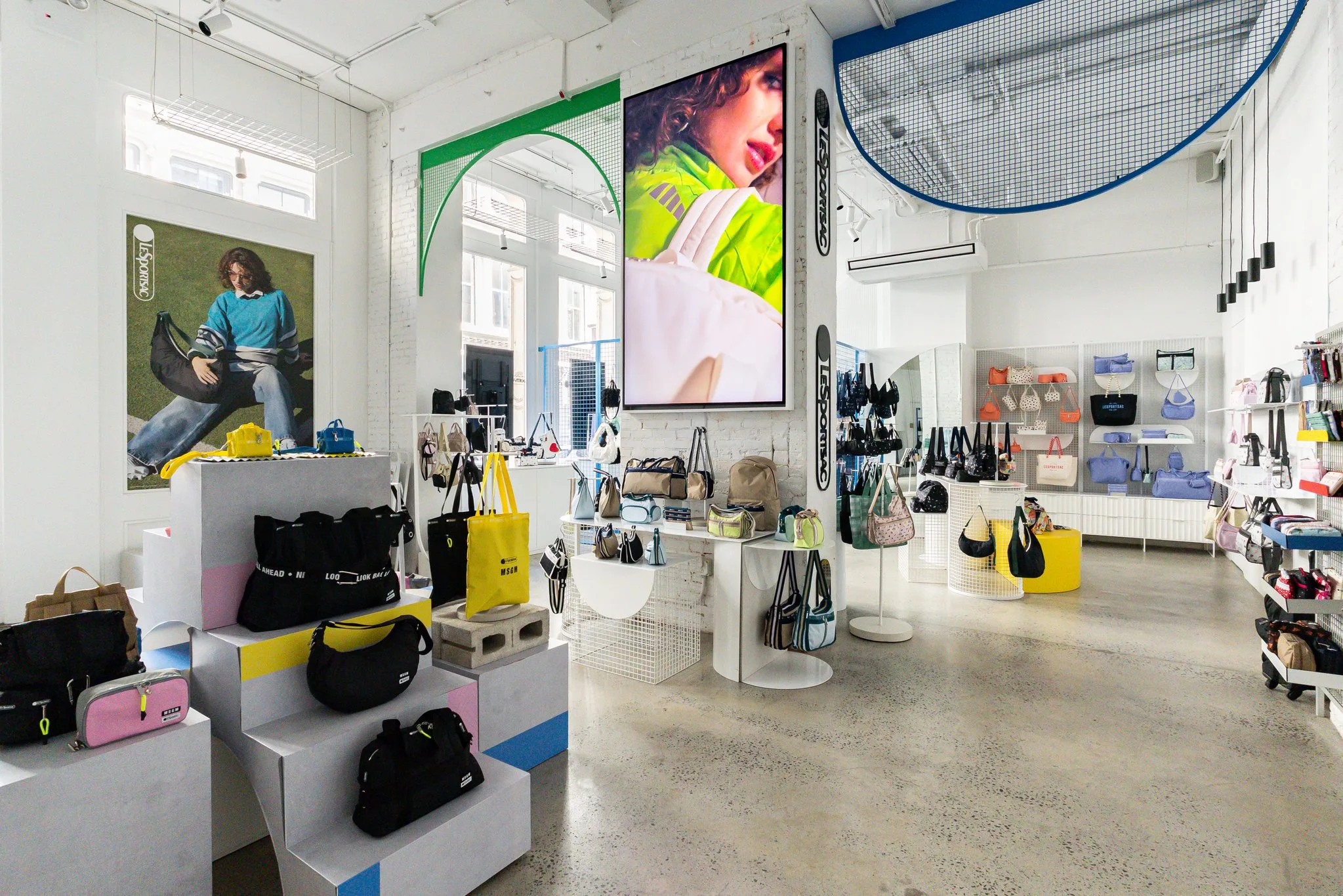 Retail store deployment with a 98-inch indoor commercial display and high-brightness window displays.