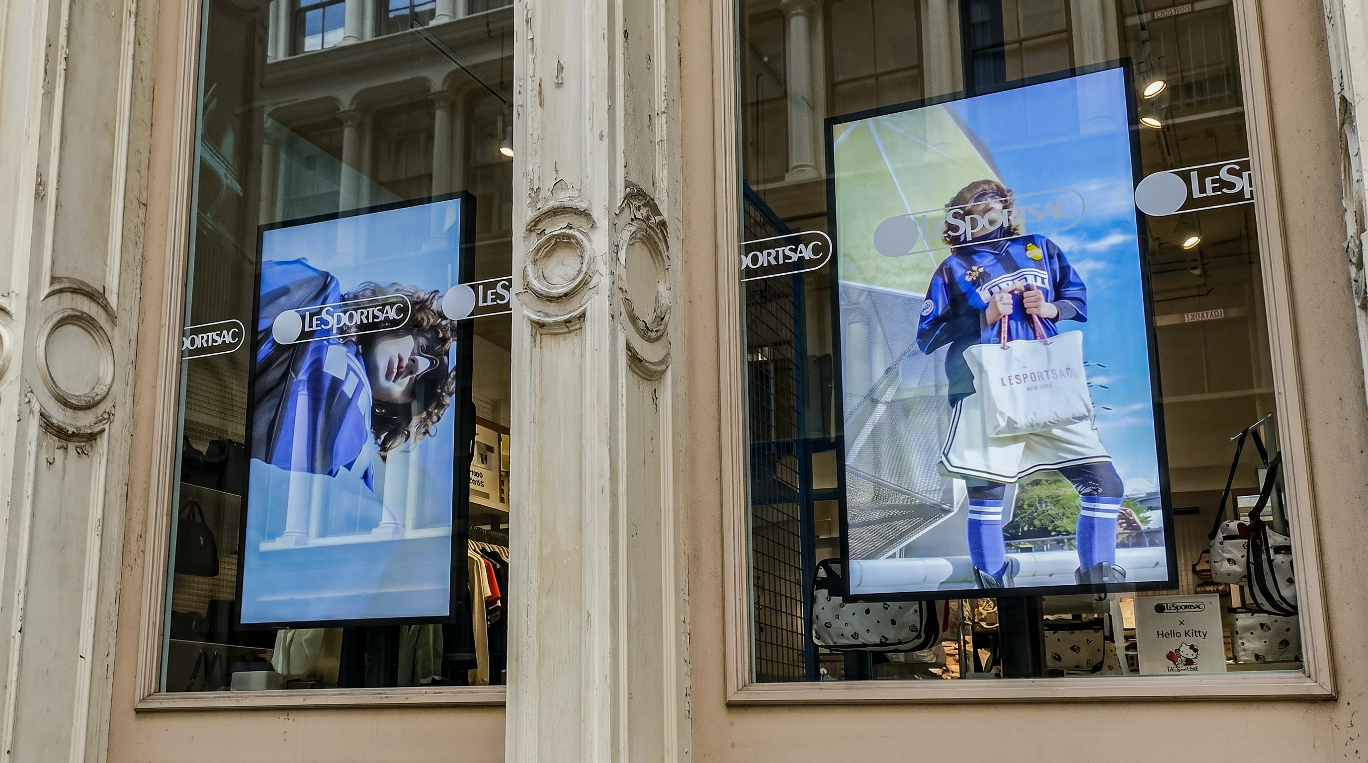 LeSportsac SoHo storefront with two high-brightness window displays visible through the glass.