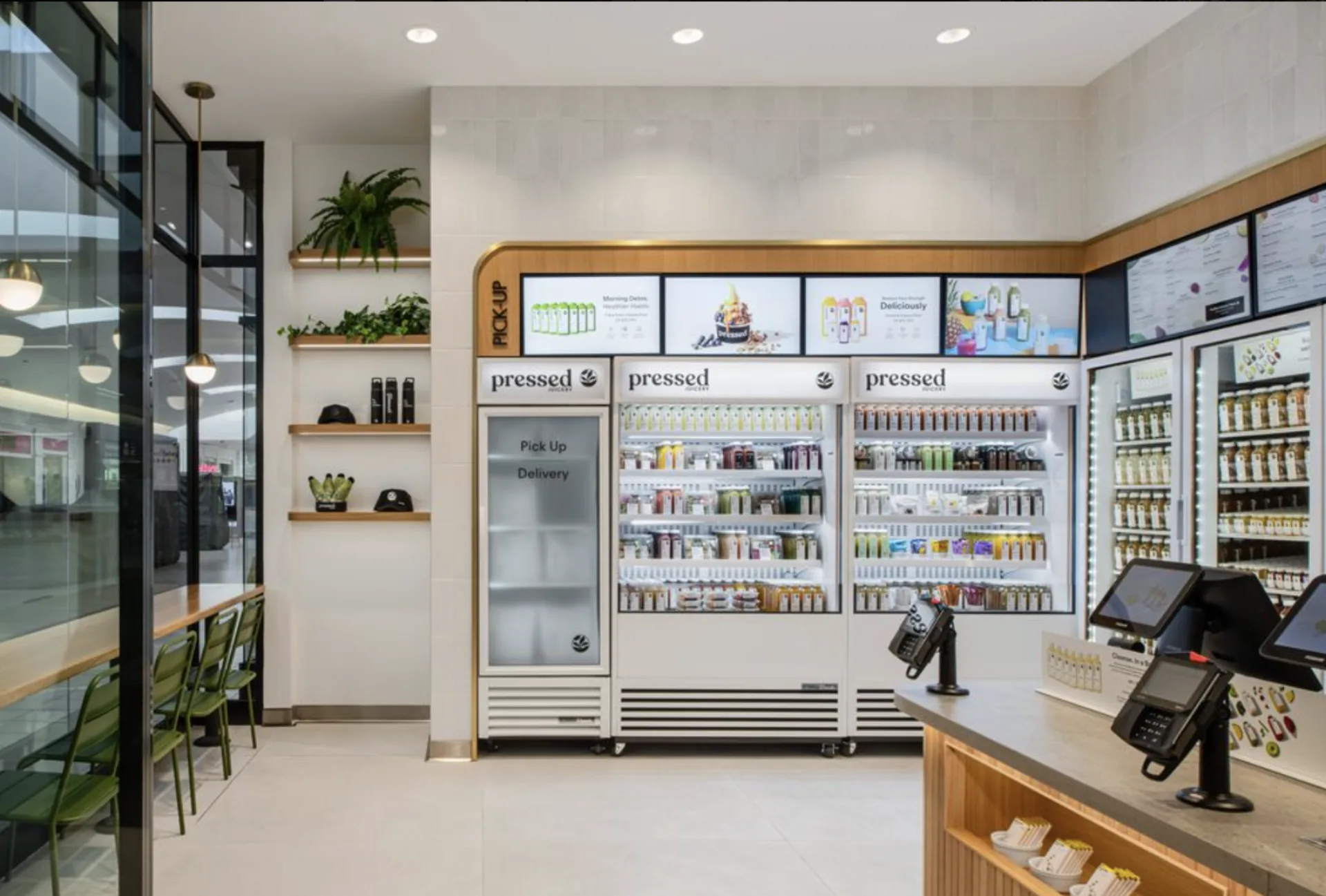 Pressed Juicery multi-screen digital menu board wall — the same display and Dashboard stack a bar program runs.