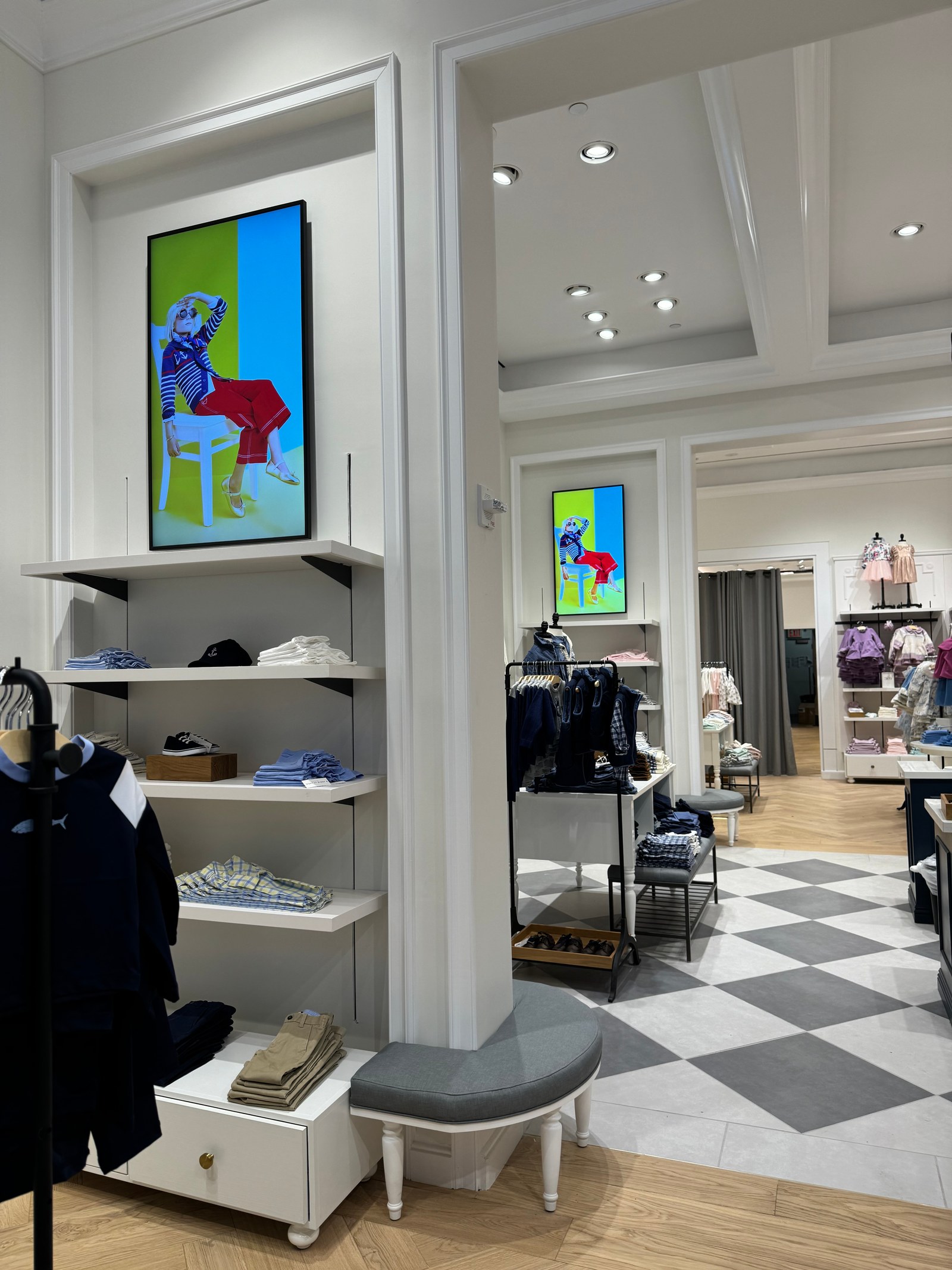 Interior of Janie and Jack Brookfield Place store featuring synchronized 4K Samsung digital displays integrated into millwork.