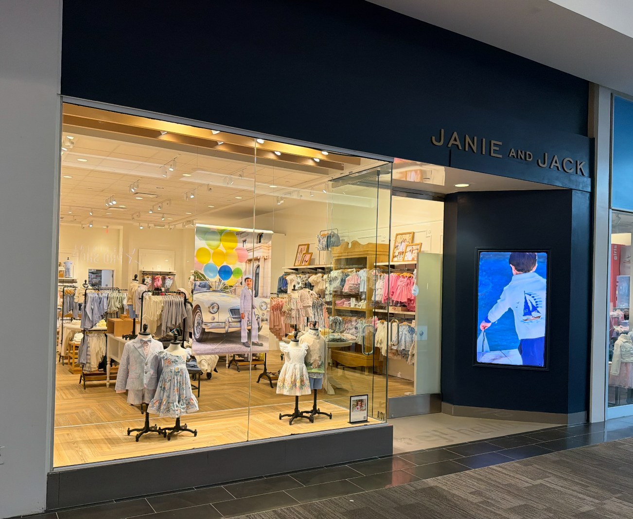 Janie and Jack mall storefront with Samsung OM55B high-brightness window display