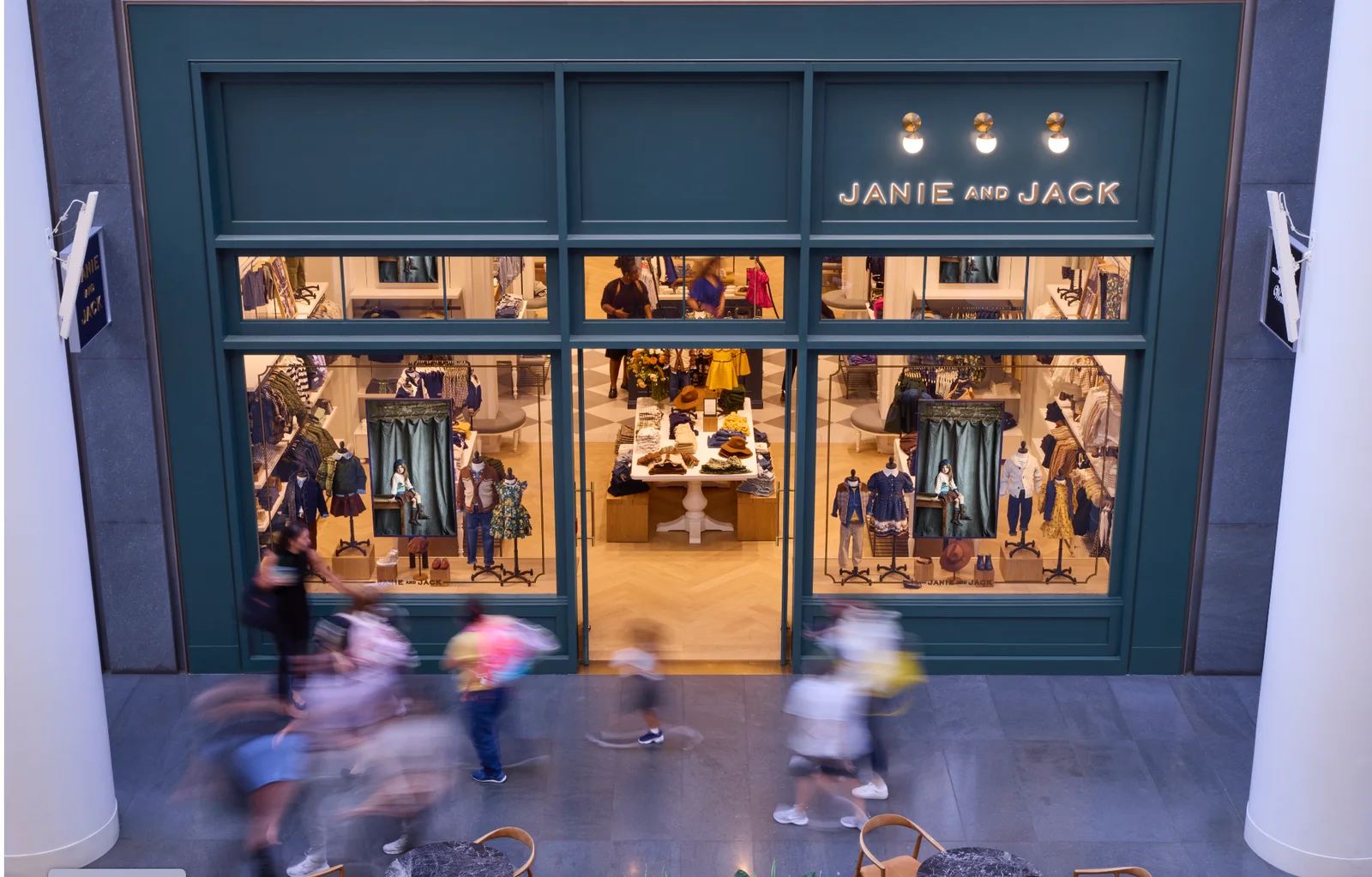 Janie and Jack storefront with CrownTV digital signage visible from the mall corridor.