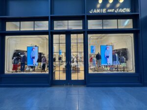 Storefront with two high-brightness window displays flanking the entrance