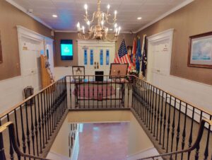 Wall-mounted digital display in lobby for announcements, branding, and wayfinding.