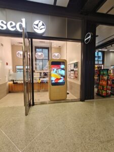 Digital entry kiosk inside restaurant highlighting specials and promotional brand content.