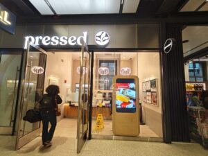 Alternate view of storefront digital kiosk promoting specials and brand messaging.