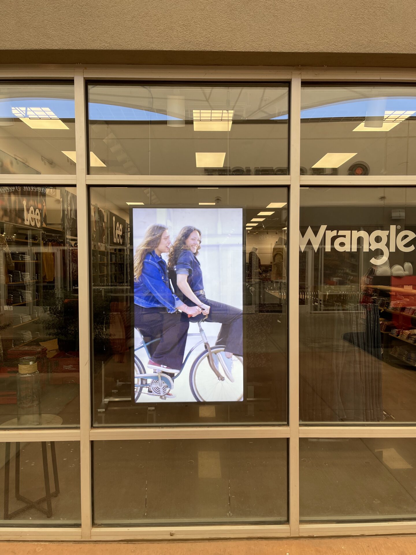 Portrait-mode digital signage TV installed in retail storefront window