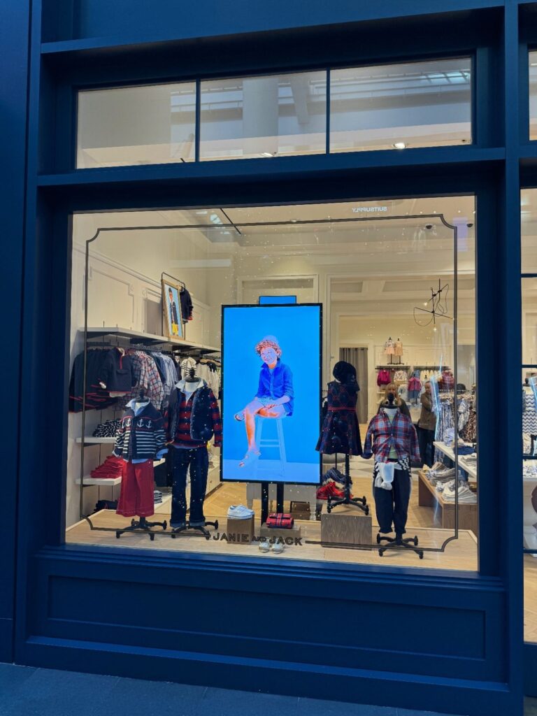 Janie and Jack storefront with synchronized CrownTV digital window displays