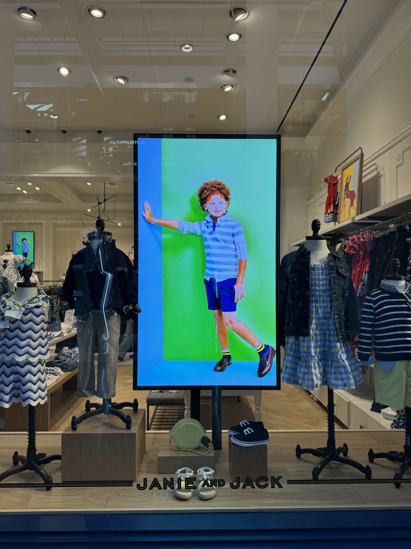 Close-up of Janie and Jack digital signage display showing seasonal campaign