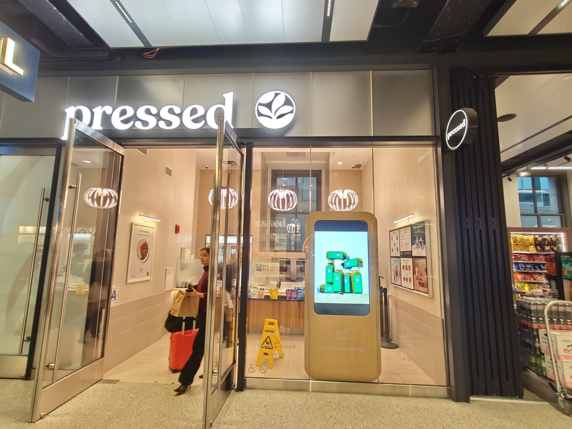 Pressed Juicery digital signage kiosk showing menu and promotions