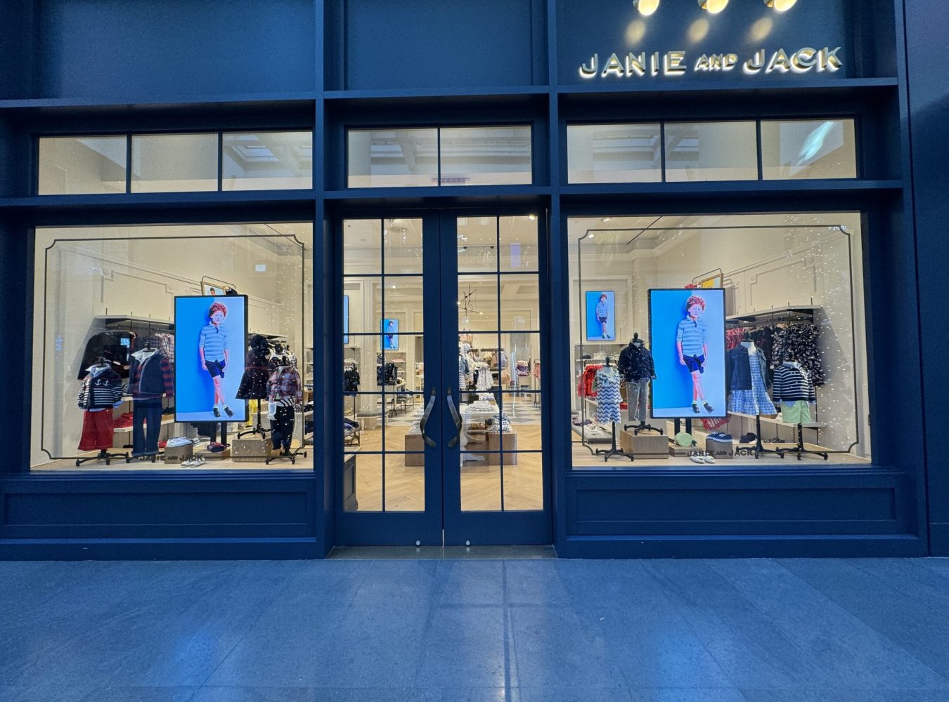 Storefront with two high-brightness window displays flanking the entrance